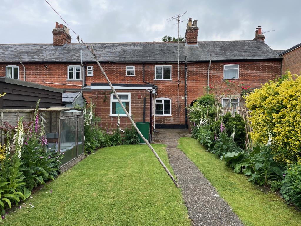 Lot: 20 - THREE-BEDROOM COTTAGE FOR IMPROVEMENT - Rear of the cottage from the end of the garden