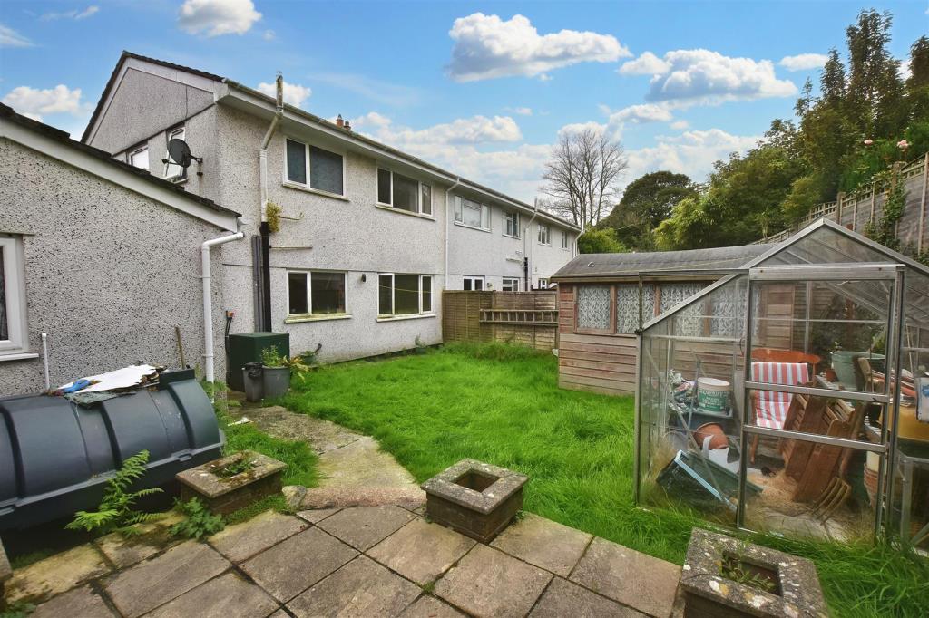 Lot: 53 - END-TERRACE HOUSE FOR IMPROVEMENT - Rear garden showing rear elevation of property, patio area, greenhouse and garden shed