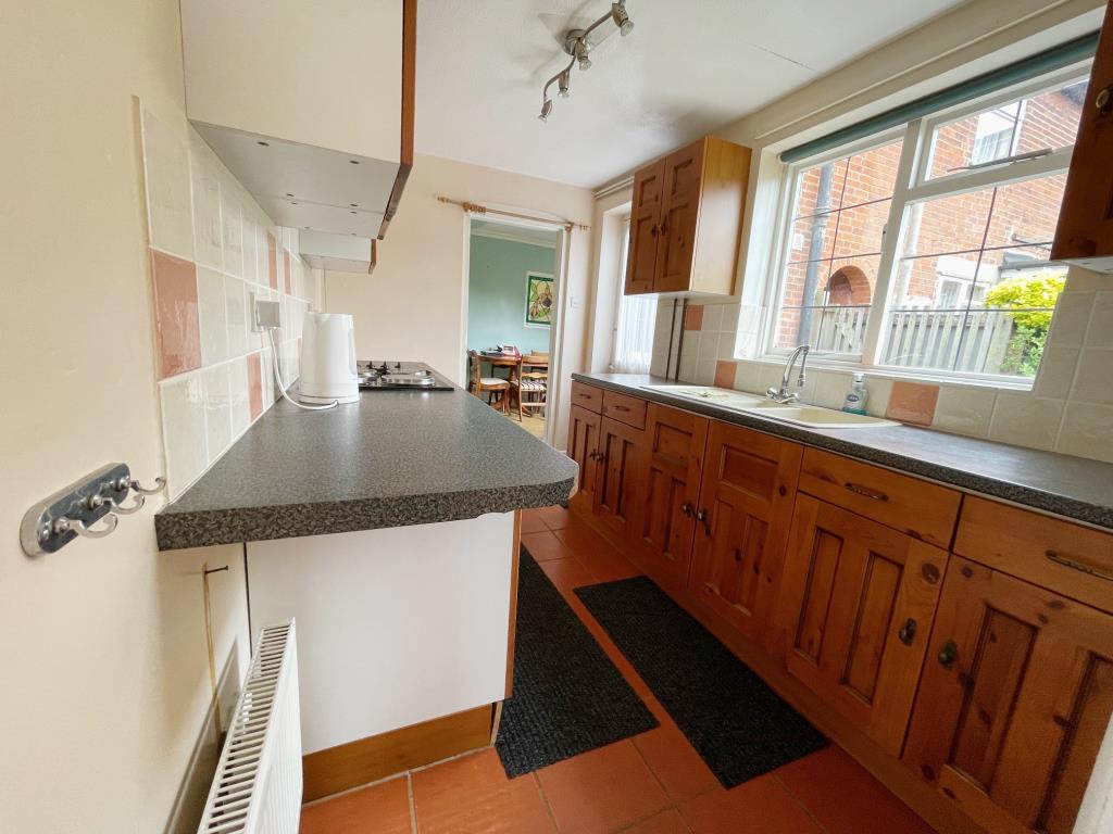 Lot: 134 - THREE-BEDROOM COTTAGE FOR IMPROVEMENT - Kitchen with window to side and door to back garden