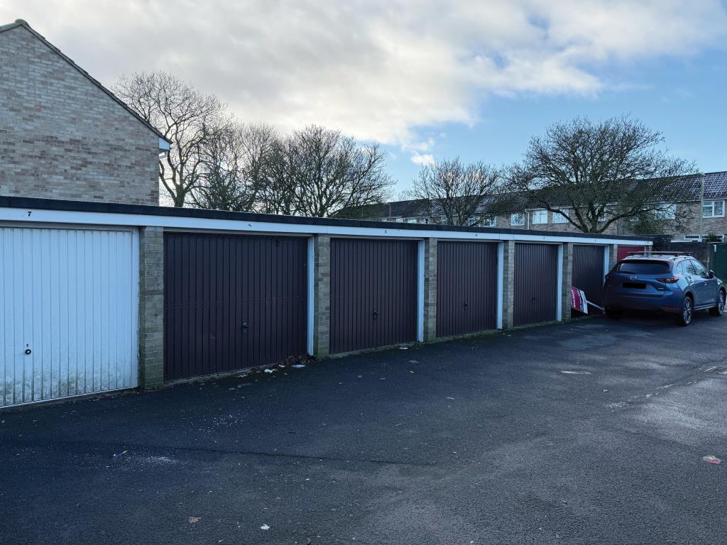 Lot: 26 - LAND WITH FIVE GARAGES WHICH FORM PART OF A LARGER BLOCK - View of garages with up and over doors