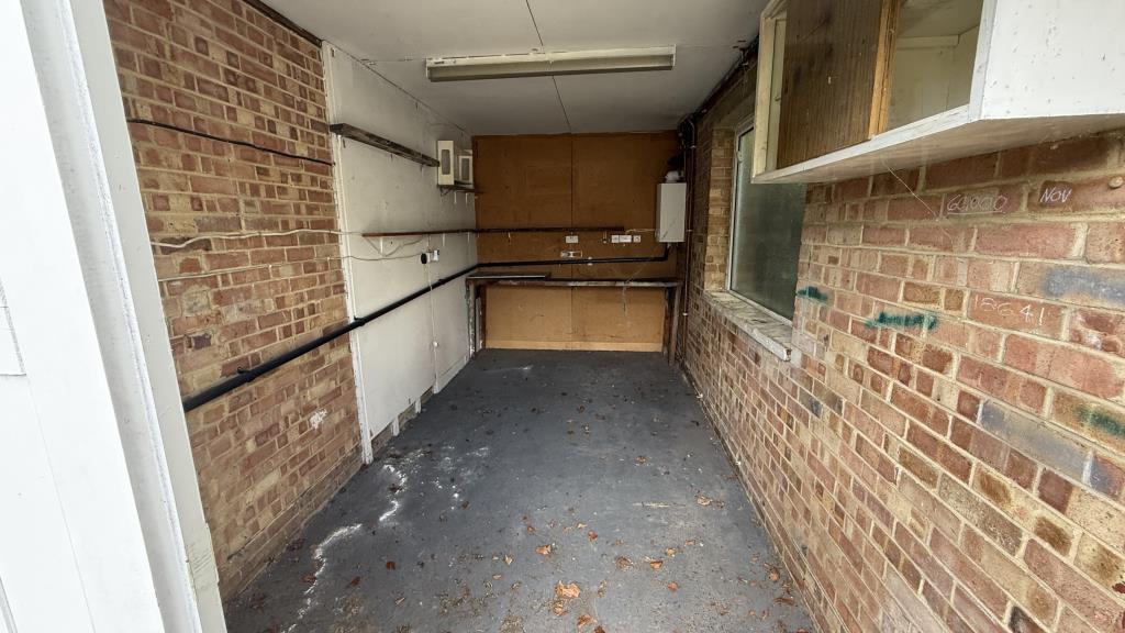 Lot: 136 - DETACHED BUNGALOW WITH GARAGE - Interior image of garage from double doors looking back