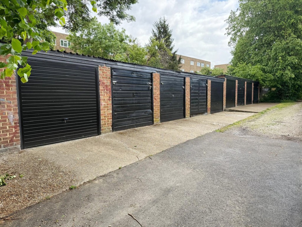 Lot: 19 - NINE FREEHOLD LOCK-UP GARAGES IN CENTRAL LOCATION - View of garages from driveway access