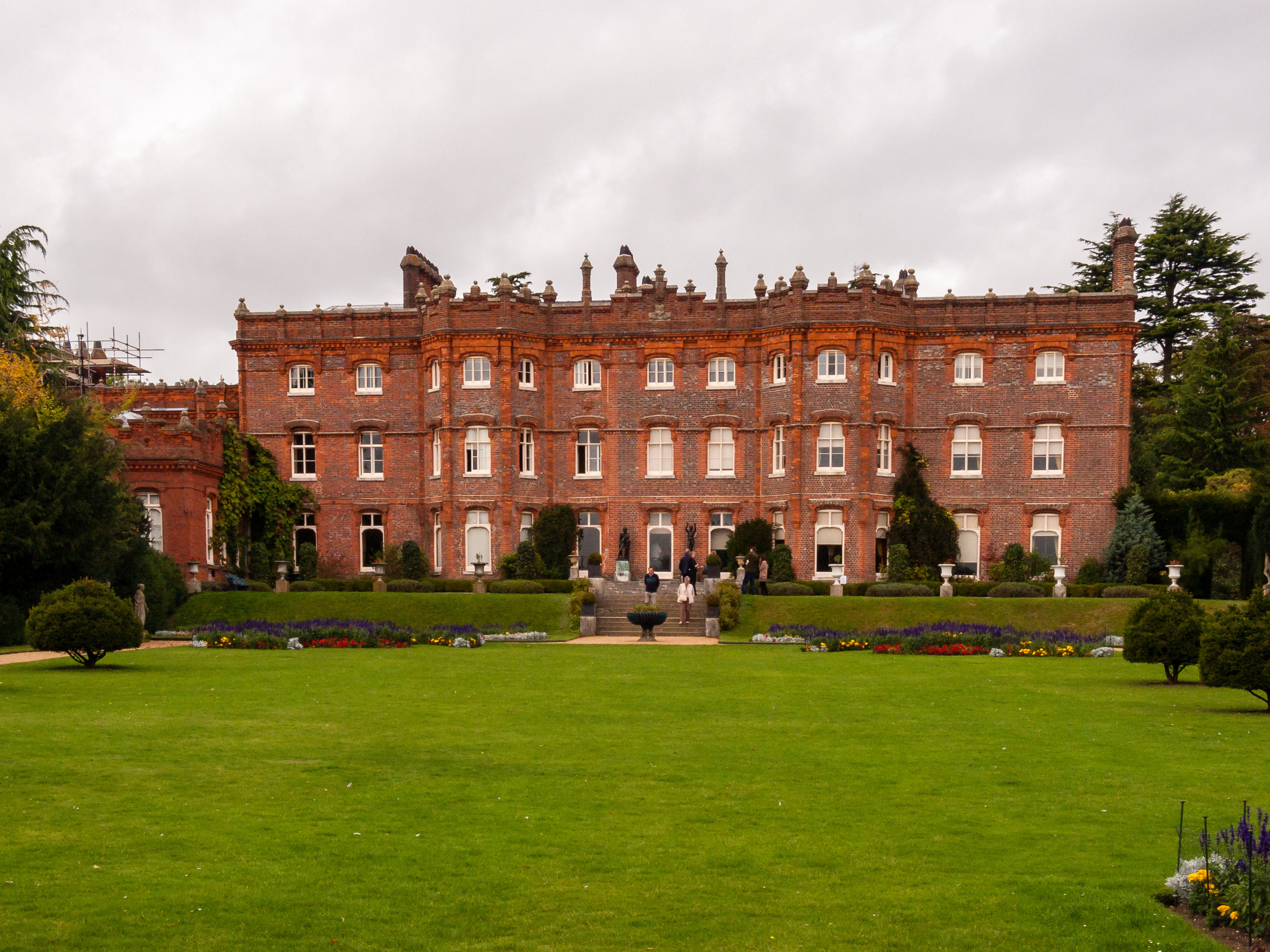 Large manor house with with grass area at front.