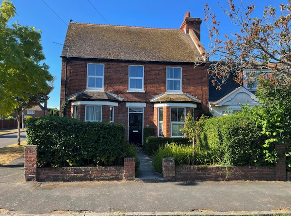 An attractive redbrick property houses a ground floor flat and gardens