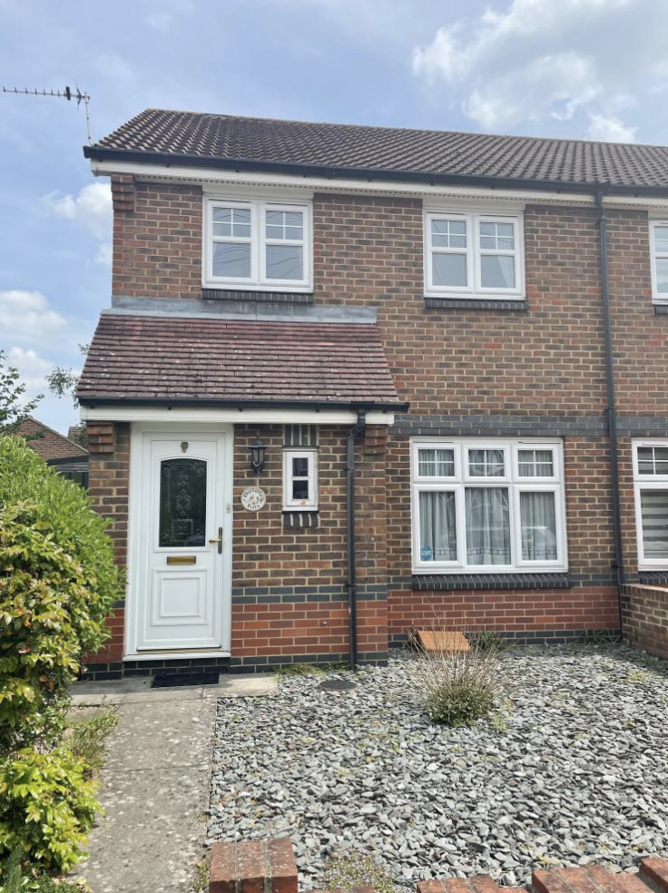 Modern brick home with slate front garden