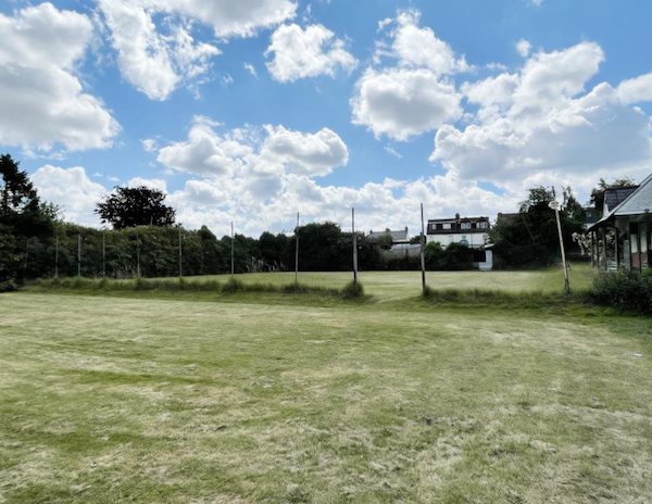 A green field with a wire fence makes up Lot 44, a piece of valuable land with planning for 7 homes