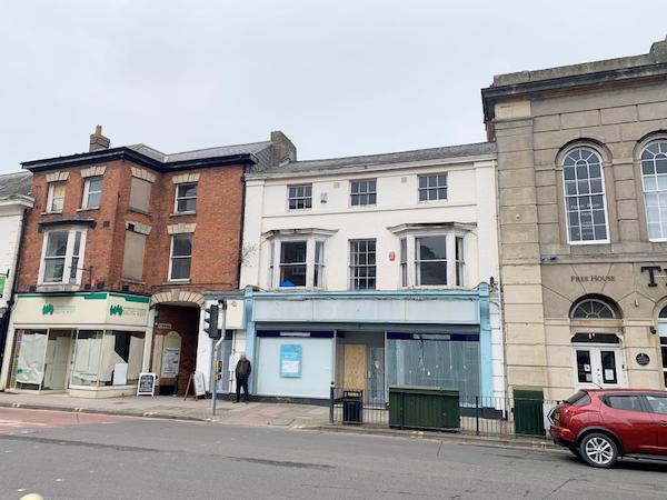 A residential property, Lot 97, is pictured on Taunton Highstreet between two large, brick properties