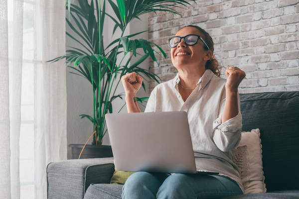 A person celebrates online auction success
